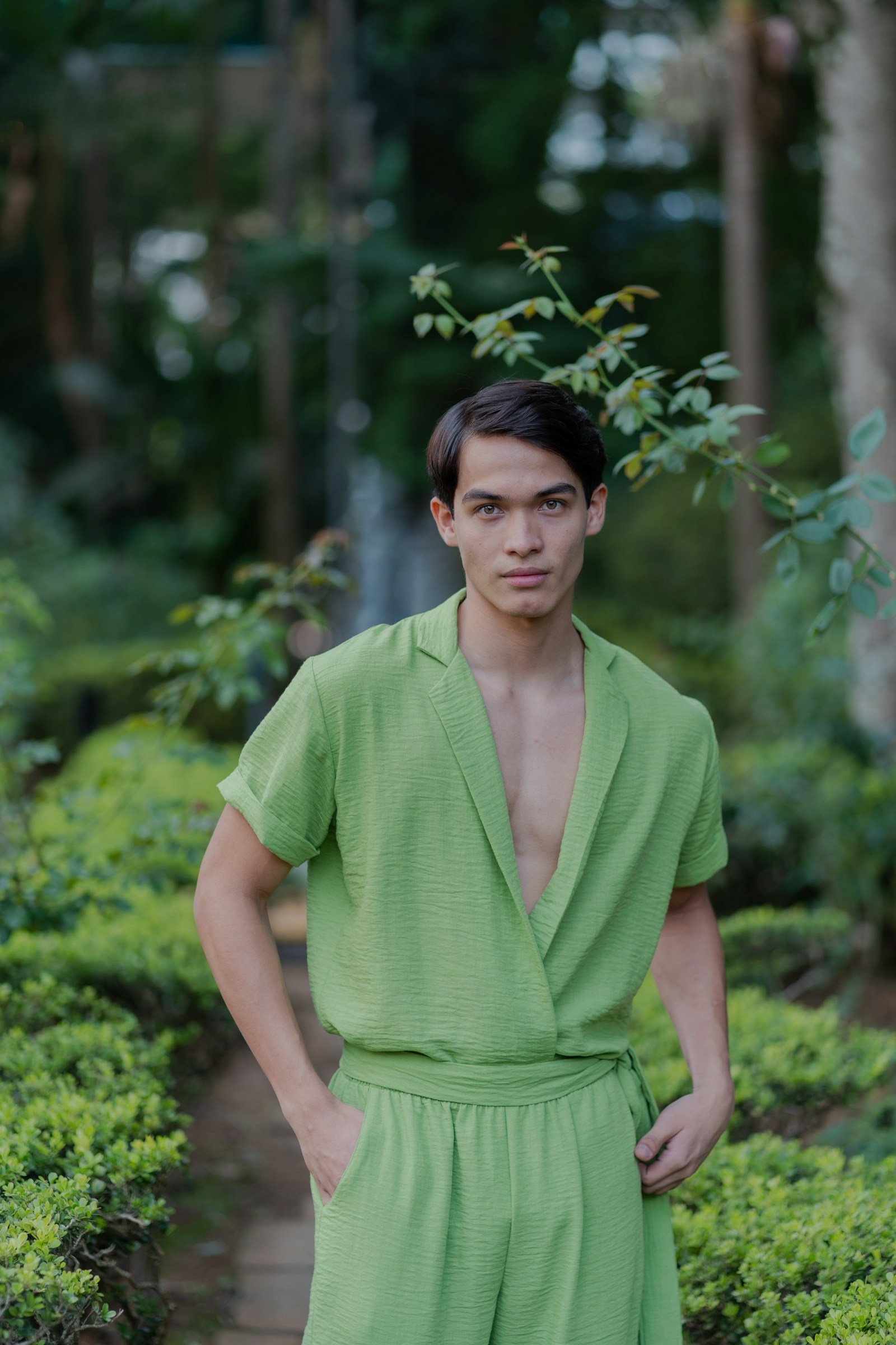 Man wearing a relaxed green outfit in a garden