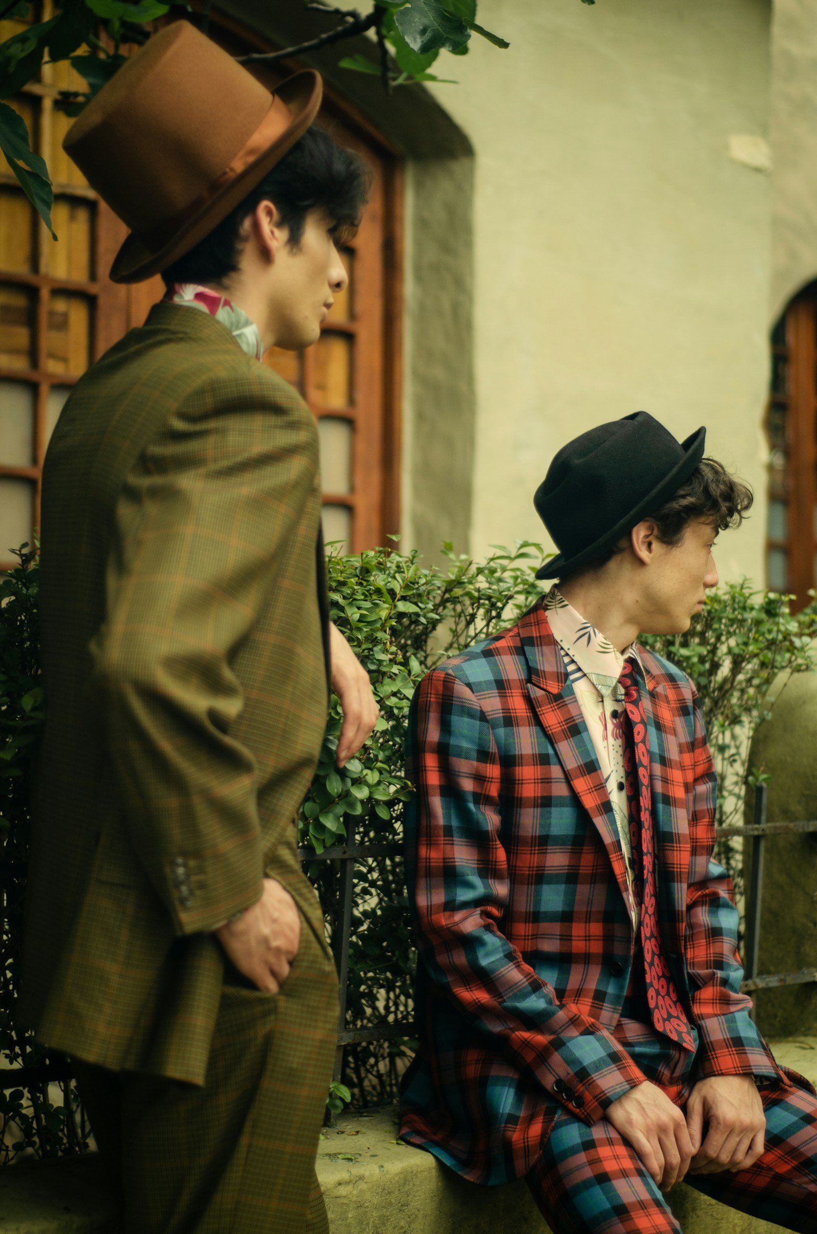 Two men in distinctive tailored suits outdoors
